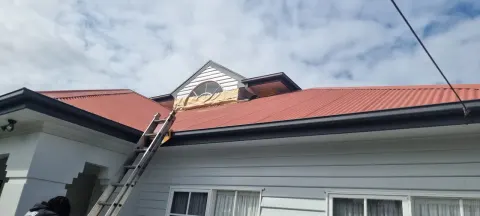Before — faded red metal roof on a heritage weatherboard home in Melbourne