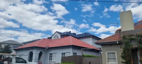 Bright red metal roof repaint in Melbourne