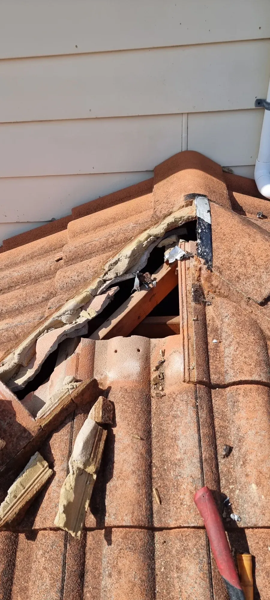Smashed ridge capping — repaired and re-flashed — before