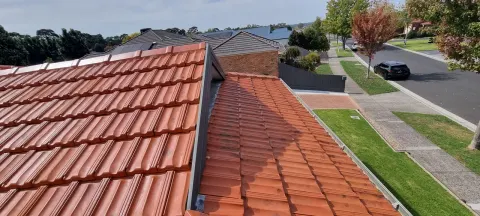 After: the same terracotta roof cleaned and restored to an even finish