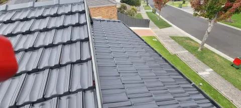 Restored charcoal roof with freshly pointed ridge caps in Melbourne