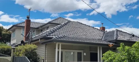 Restored charcoal tiled roof seen from the front of the home in Melbourne