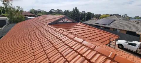 Before: a Melbourne home with a tired orange terracotta tiled roof